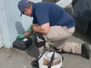 1st-pest-control-technician-servicing-a-bait-station